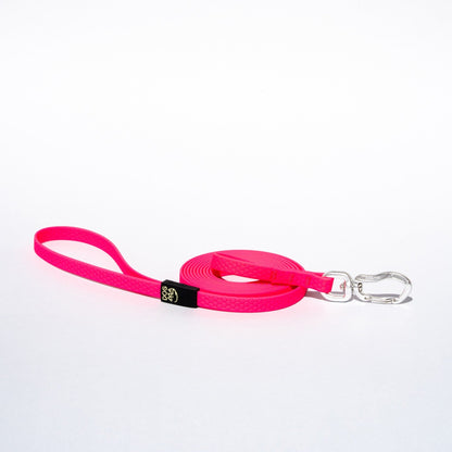 Pink dog leash with a clip on a white background