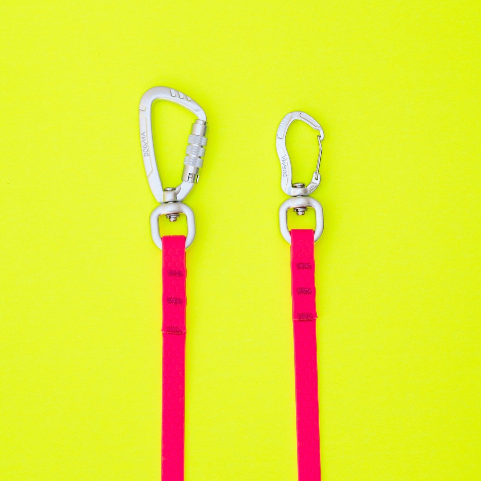 Two pink carabiners with clips on a yellow background