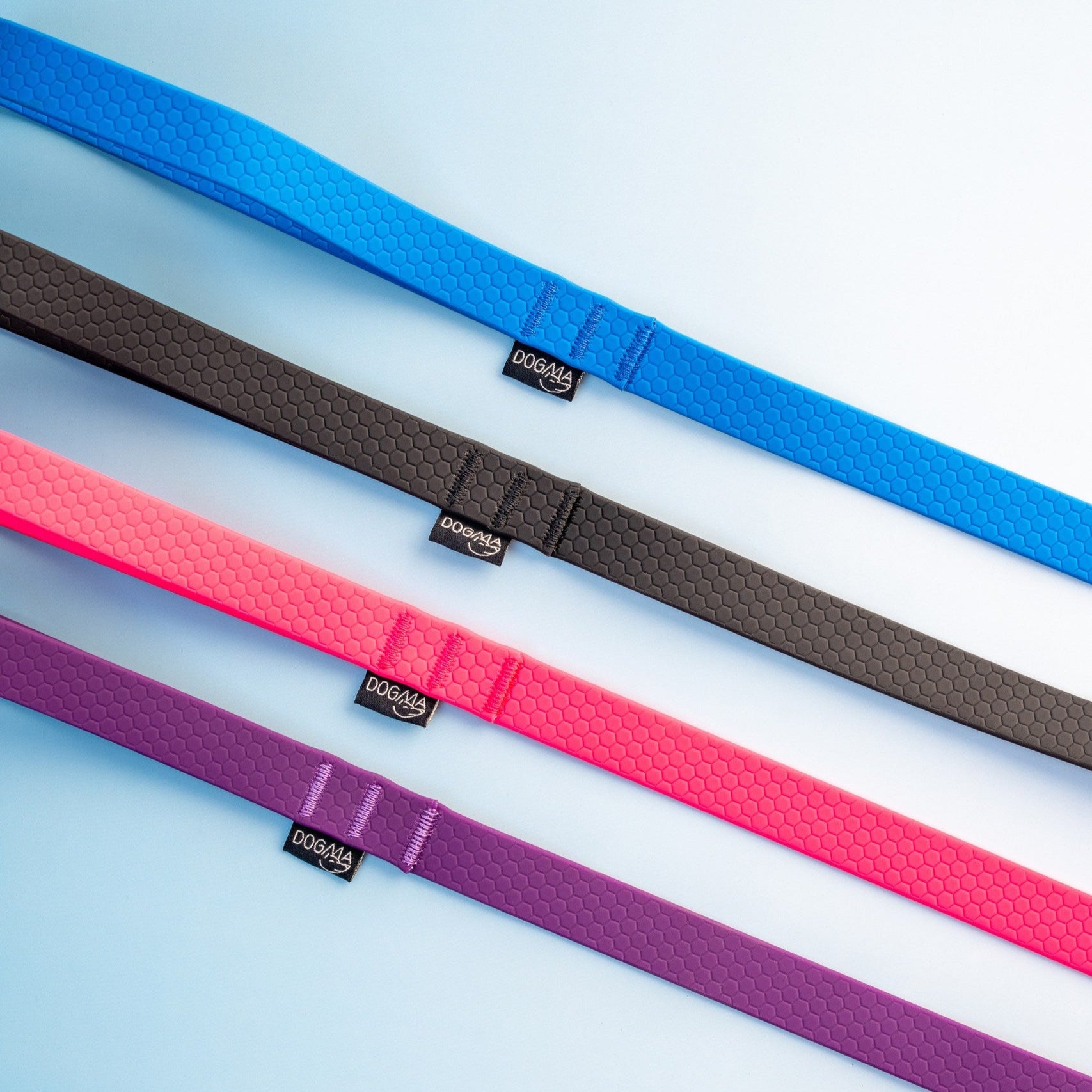 Four colorful belts (blue, brown, pink, purple) on a light blue background